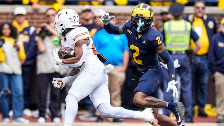 Michigan defensive back Will Johnson defends Texas running back Jaydon Blue during the first half at Michigan Stadium in Ann Arbor on Saturday, Sept. 7, 2024.