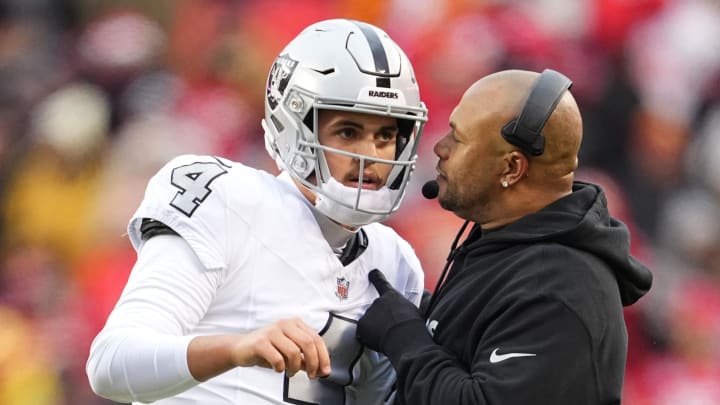 Dec 25, 2023; Kansas City, Missouri, USA; Las Vegas Raiders quarterback Aidan O'Connell (4) talks with head coach Antonio Pierce during the second half against the Las Vegas Raiders at GEHA Field at Arrowhead Stadium. Mandatory Credit: Jay Biggerstaff-USA TODAY Sports