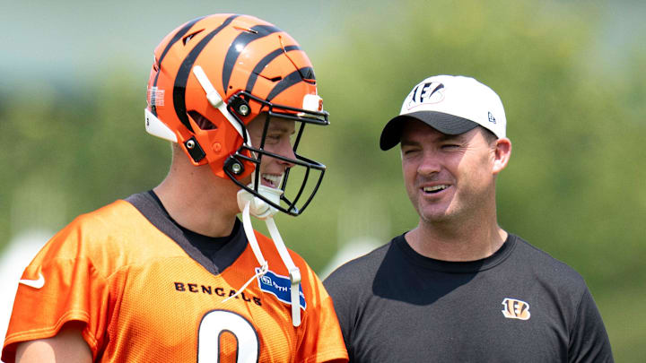 Cincinnati Bengals quarterback Joe Burrow (9) talks with Cincinnati Bengals head coach Zac Taylor during Cincinnati Bengals training camp in Cincinnati on Friday, July 26, 2024. Cincinnati Bengals quarterback Joe Burrow (9) talks with Cincinnati Bengals head coach Zac Taylor during Cincinnati Bengals training camp in Cincinnati on Friday, July 26, 2024.
