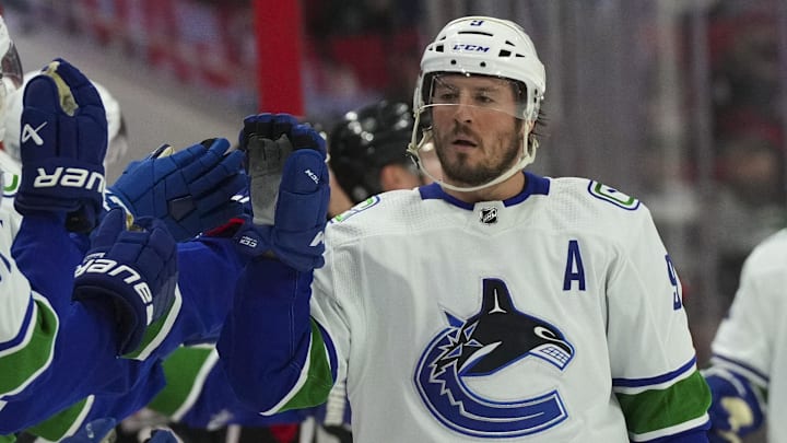 Jan 15, 2023; Raleigh, North Carolina, USA;  Vancouver Canucks center J.T. Miller (9) celebrates his goals against the Carolina Hurricanes during the third period at PNC Arena. Mandatory Credit: James Guillory-Imagn Images