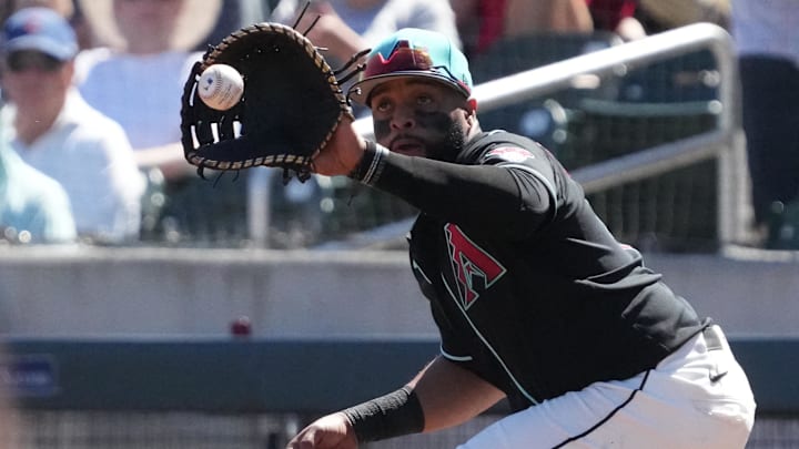 Mar 18, 2026; Salt River Pima-Maricopa, Arizona, USA; Arizona Diamondbacks first baseman Carlos Santana (41) makes the play against the Chicago Cubs in the first inning at Salt River Fields at Talking Stick. Mandatory Credit: Rick Scuteri-Imagn Images