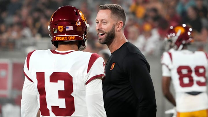 The former Arizona Cardinals head coach and now USC Trojans assistant coach Kliff Kingsbury talks to