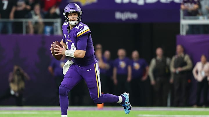 Dec 8, 2024; Minneapolis, Minnesota, USA; Minnesota Vikings quarterback Sam Darnold (14) scrambles with the ball against the Atlanta Falcons during the third quarter at U.S. Bank Stadium.