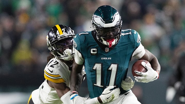 Dec 15, 2024; Philadelphia, Pennsylvania, USA; Philadelphia Eagles wide receiver A.J. Brown (11) runs with the ball against Pittsburgh Steelers cornerback James Pierre (42) after a catch during the fourth quarter at Lincoln Financial Field.