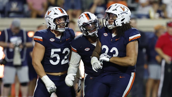 Sep 20, 2025; Charlottesville, Virginia, USA; Virginia Cavaliers defensive lineman Jacob Holmes (23) celebrates with teammates after recording a sack against the Stanford Cardinal during the third quarter at Scott Stadium. Mandatory Credit: Geoff Burke-Imagn Images Sep 20, 2025; Charlottesville, Virginia, USA; Virginia Cavaliers defensive lineman Jacob Holmes (23) celebrates with teammates after recording a sack against the Stanford Cardinal during the third quarter at Scott Stadium. Mandatory Credit: Geoff Burke-Imagn Images