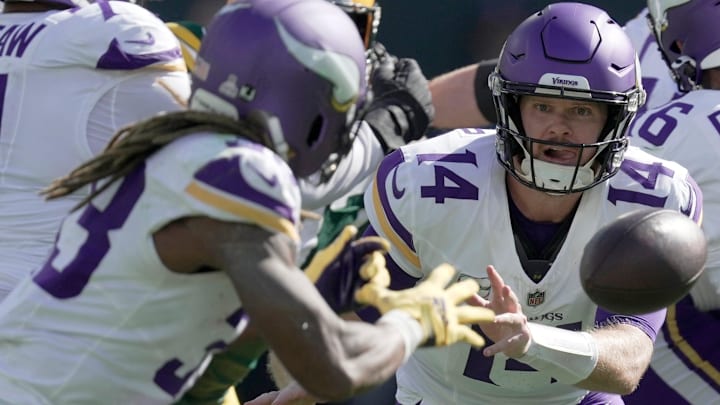 Minnesota Vikings quarterback Sam Darnold (14) pitches the ball to running back Aaron Jones (33) during the third quarter of their game Sunday, September 29, 2024 at Lambeau Field in Green Bay, Wisconsin. The Minnesota Vikings beat the Green Bay Packers 31-29.