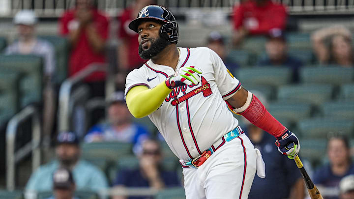 Aug 7, 2025; Cumberland, Georgia, USA; Atlanta Braves designated hitter Marcell Ozuna (20) hits a home run against the Miami Marlins during the second inning at Truist Park. Mandatory Credit: Dale Zanine-Imagn Images