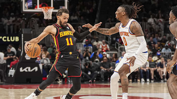 Apr 5, 2025; Atlanta, Georgia, USA; Atlanta Hawks guard Trae Young (11) tries to avoid the defense of New York Knicks guard Delon Wright (0) during the second half at State Farm Arena. Mandatory Credit: Dale Zanine-Imagn Images