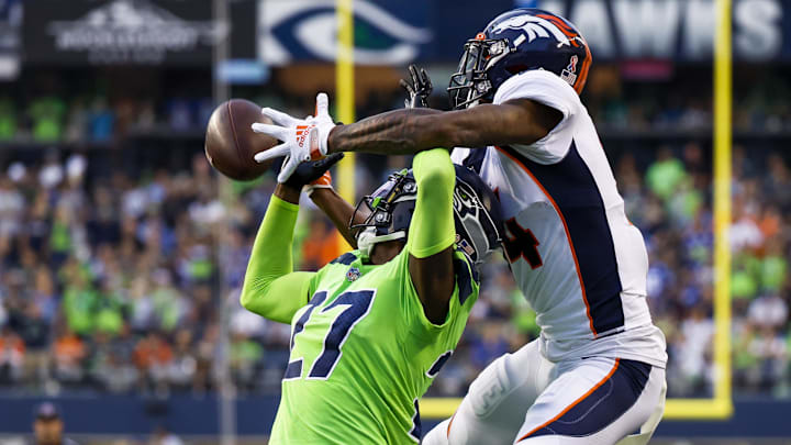 Sep 12, 2022; Seattle, Washington, USA; Denver Broncos cornerback Riq Woolen (27) breaks up a pass intended for Denver Broncos wide receiver Courtland Sutton (14) during the third quarter at Lumen Field. Images