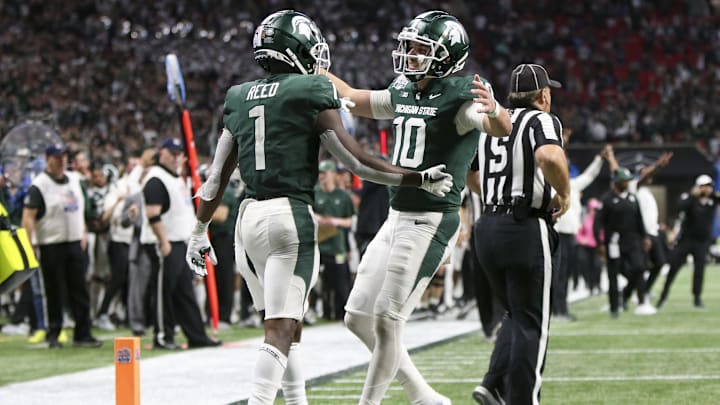 Dec 30, 2021; Atlanta, GA, USA; Michigan State Spartans wide receiver Jayden Reed (1) and quarterback Payton Thorne (10) celebrate after a touchdown against the Pittsburgh Panthers in the second half during the 2021 Peach Bowl at Mercedes-Benz Stadium. Mandatory Credit: Brett Davis-Imagn Images