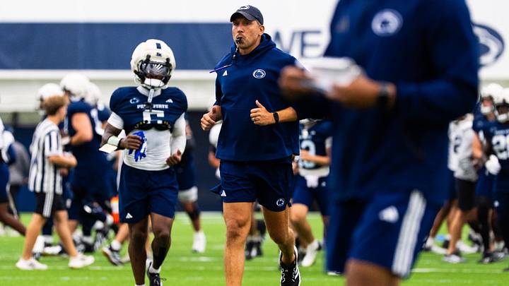 Penn State football head coach Matt Campbell jogs at the start of a practice session inside Holuba Hall on Monday, August 10, 2026, in State College.
