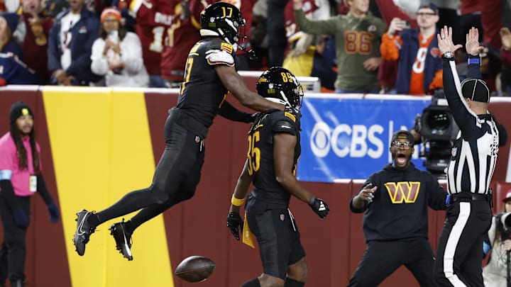 Brown celebrates with teammates after catching a game-winnning Hail Mary from Jayden Daniels.