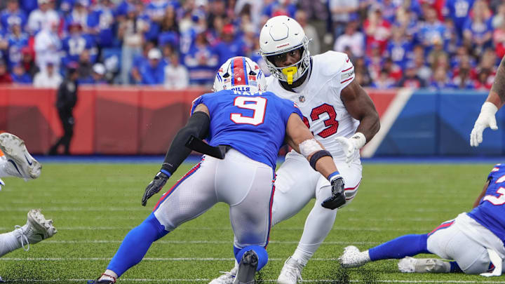 Sep 8, 2024; Orchard Park, New York, USA; Arizona Cardinals running back Trey Benson (33) runs with the ball against Buffalo Bills safety Taylor Rapp (9) 