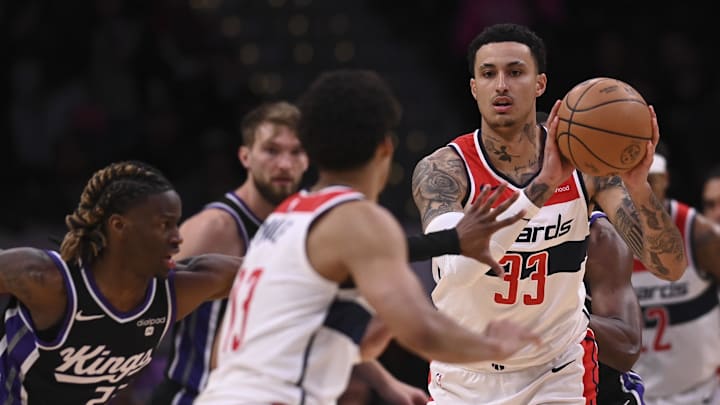 Mar 21, 2024; Washington, District of Columbia, USA;  Washington Wizards forward Kyle Kuzma (33) passes as Sacramento Kings center Alex Len (25) defends during the first half at Capital One Arena. Mandatory Credit: Tommy Gilligan-Imagn Images