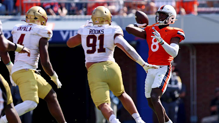 Oct 5, 2024; Charlottesville, Virginia, USA; Virginia Cavaliers wide receiver Malachi Fields (8) throws a pass against Boston College Eagles defensive lineman George Rooks (91) during the third quarter at Scott Stadium. Mandatory Credit: Peter Casey-Imagn Images