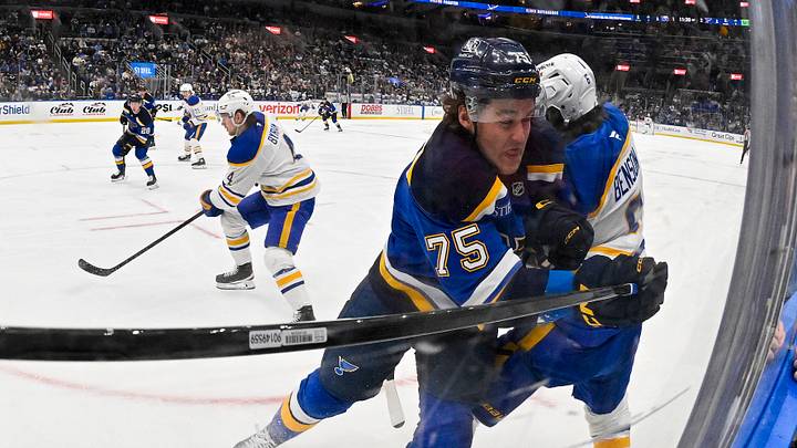 Dec 29, 2025; St. Louis, Missouri, USA; St. Louis Blues defenseman Tyler Tucker (75) checks Buffalo Sabres left wing Zach Benson (6) during the first period at Enterprise Center. Mandatory Credit: Jeff Curry-Imagn Images