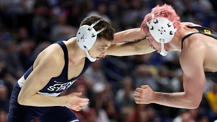 Penn State’s Luke Lilledahl (left) wrestles Iowa’s Dean Peterson (right) in a 125-pound bout during the quarterfinals of the Big Ten Wrestling Championships at Bryce Jordan Center. 