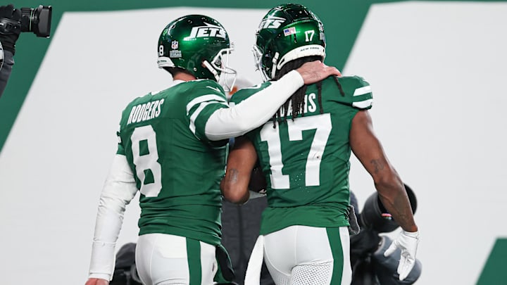 Jan 5, 2025; East Rutherford, New Jersey, USA; New York Jets quarterback Aaron Rodgers (8) and wide receiver Davante Adams (17) celebrate after a touchdown during the second half against the Miami Dolphins at MetLife Stadium. Mandatory Credit: Vincent Carchietta-Imagn Images