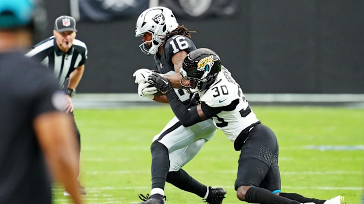 Nov 2, 2025; Paradise, Nevada, USA; Jacksonville Jaguars cornerback Montaric Brown (30) tackles Las Vegas Raiders wide receiver Jakobi Meyers (16) during the second half at Allegiant Stadium. Mandatory Credit: Stephen R. Sylvanie-Imagn Images