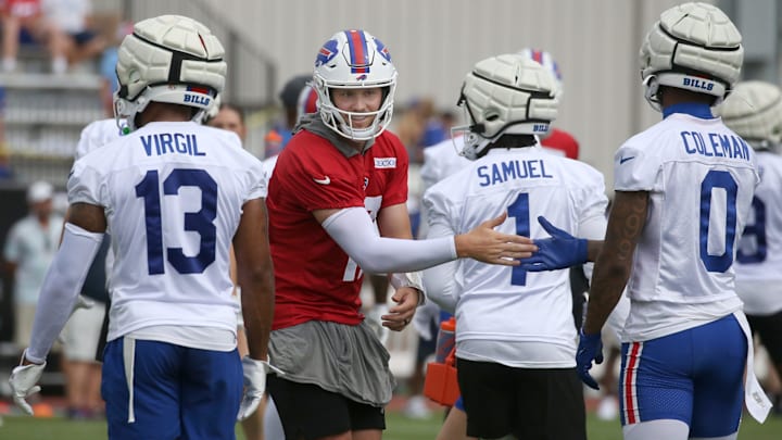 Bills quarterback Josh Allen goes through his unique handshake with Keon Coleman as the offense wraps up a practice period