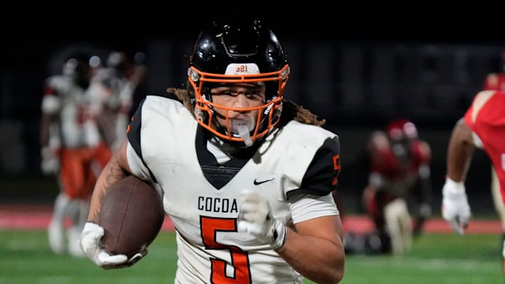 Cocoa High wide receiver Jayvan Boggs (#5) finds room to run against the Cardinal Mooney defense. Cocoa High School defeated Cardinal Mooney Catholic High School 31-21 to win the Class 2A semi-final game Friday night in Sarasota.