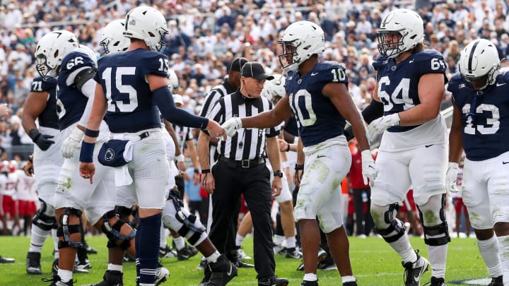 Penn State Nittany Lions quarterback Drew Allar (15) congratulates running back Nicholas Singleton after Singleton scored a touchdown in a 2023 game against Indiana. 