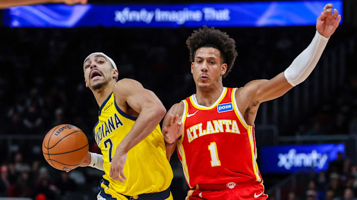 Jan 26, 2026; Atlanta, Georgia, USA; Indiana Pacers guard Kam Jones (7) dribbles the ball towards the basket against Atlanta Hawks forward Jalen Johnson (1) during the third quarter at State Farm Arena. Mandatory Credit: Jordan Godfree-Imagn Images