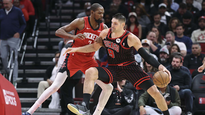 Jan 13, 2026; Houston, Texas, USA; Chicago Bulls center Nikola Vucevic (9) controls the ball as Houston Rockets forward Kevin Durant (7) defends during the third quarter at Toyota Center. Mandatory Credit: Troy Taormina-Imagn Images