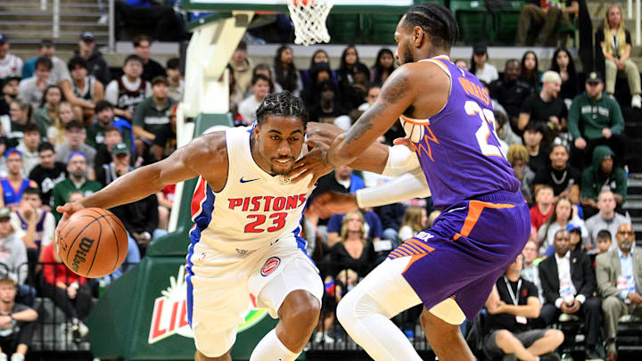 Oct 8, 2024; East Lansing, Michigan, USA;  Detroit Pistons guard Jaden Ivey (23) drives against Phoenix Suns guard Monte Morris (23) at Jack Breslin Student Events Center. Mandatory Credit: Dale Young-Imagn Images