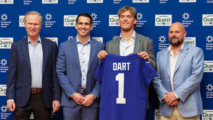 Apr 25, 2025; East Rutherford, NJ, US; New York Giants president John Mara (far left), general manager Joe Schoen (left), Jaxson Dart, and head coach Brian Daboll (right) pose for photos prior to the start of the press conference to introduce the Giants first round draft picks.   