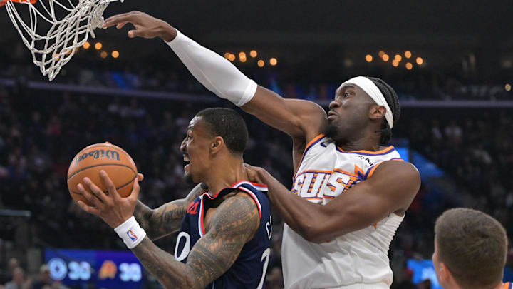 Oct 24, 2025; Inglewood, California, USA; Los Angeles Clippers forward John Collins (20) is defended by Phoenix Suns center Mark Williams (15) as he drives to the basket in the first half at Intuit Dome. Mandatory Credit: Jayne Kamin-Oncea-Imagn Images
