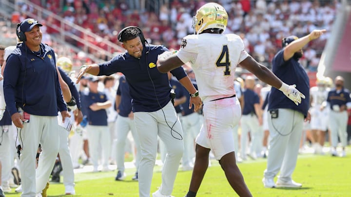 Sep 27, 2025; Fayetteville, Arkansas, USA; Notre Dame Fighting Irish head coach Marcus Freeman celebrates with running back Jeremiyah Love (4) after a touchdown in the second quarter against the Arkansas Razorbacks at Donald W. Reynolds Razorback Stadium. Mandatory Credit: Nelson Chenault-Imagn Images