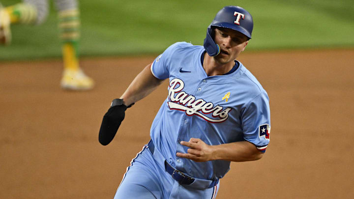 Sep 1, 2024; Arlington, Texas, USA; Texas Rangers shortstop Corey Seager (5) scores from second base on a double hit by right fielder Adolis Garcia (not pictured) during the first inning at Globe Life Field. 