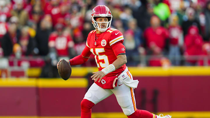 Nov 29, 2024; Kansas City, Missouri, USA; Kansas City Chiefs quarterback Patrick Mahomes (15) rolls out to pass during the first half against the Las Vegas Raiders at GEHA Field at Arrowhead Stadium. Mandatory Credit: Jay Biggerstaff-Imagn Images