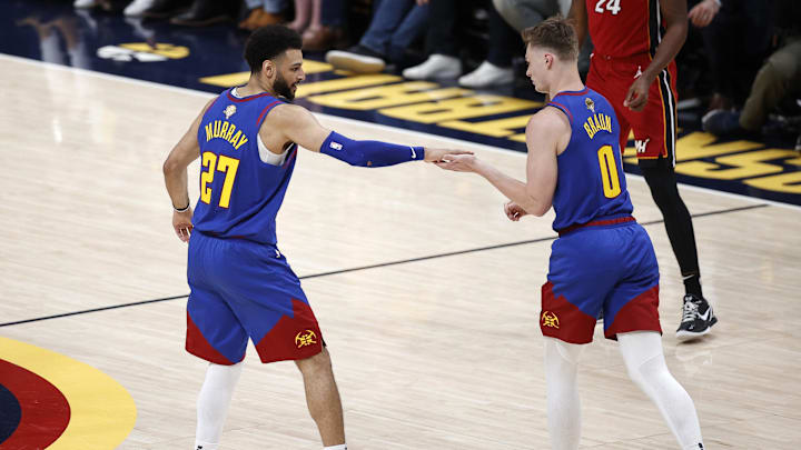 Jun 1, 2023; Denver, CO, USA; Denver Nuggets guard Christian Braun (0) is congratulated by guard Jamal Murray (27) after a play during the second quarter against the Miami Heat in game one of the 2023 NBA Finals at Ball Arena. Mandatory Credit: Isaiah J. Downing-Imagn Images