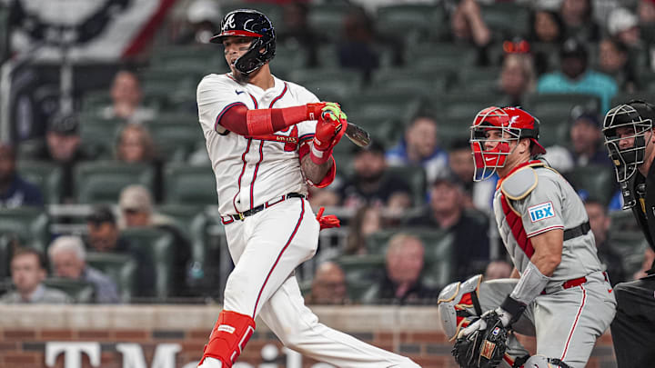 Apr 9, 2025; Cumberland, Georgia, USA; Atlanta Braves shortstop Orlando Arcia (11) singles to drive in a run against the Philadelphia Phillies during the sixth inning at Truist Park. Mandatory Credit: Dale Zanine-Imagn Images