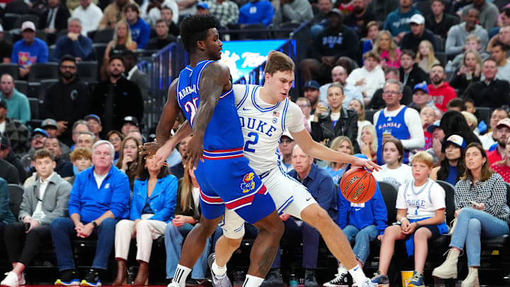 Nov 26, 2024; Las Vegas, Nevada, USA; Duke Blue Devils guard Cooper Flagg (2) dribbles against Kansas Jayhawks forward KJ Adams Jr. (24) during the first half at T-Mobile Arena. Mandatory Credit: Stephen R. Sylvanie-Imagn Images