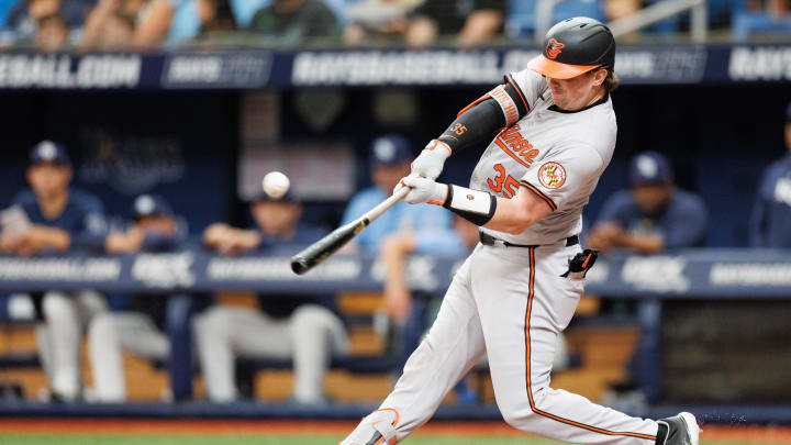 Jun 9, 2024; St. Petersburg, Florida, USA;  Baltimore Orioles catcher Adley Rutschman (35) hits an rbi single against the Tampa Bay Rays in the third inning at Tropicana Field. Mandatory Credit: Nathan Ray Seebeck-USA TODAY Sports