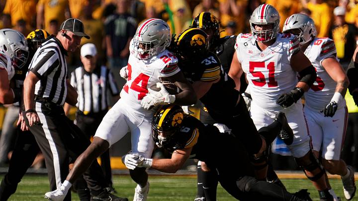 Ohio State Buckeyes running back Ja'kobi Jackson (24) runs through Iowa Hawkeyes defensive back Zach Lutmer (6) and linebacker Cam Buffington (33) during the NCAA football game at Kinnick Stadium in Iowa City on Oct. 3, 2026.