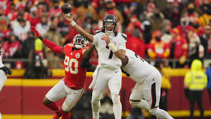 Jan 18, 2025; Kansas City, Missouri, USA; Houston Texans quarterback C.J. Stroud (7) throws a pass against Kansas City Chiefs defensive end Charles Omenihu (90) during the third quarter of a 2025 AFC divisional round game at GEHA Field at Arrowhead Stadium.
