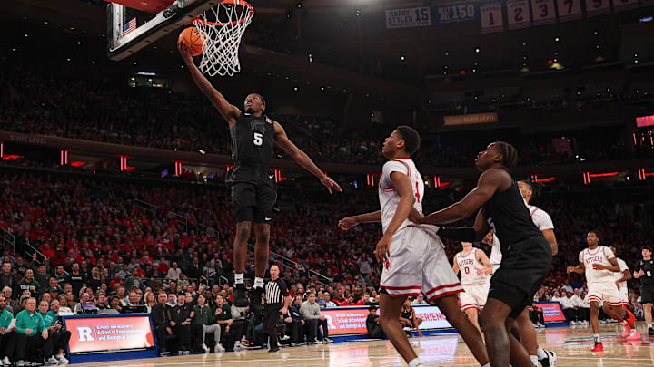 Jan 25, 2025; New York, New York, USA; Michigan State Spartans guard Tre Holloman (5) goes to the basket against the Rutgers Scarlet Knights during the second half at Madison Square Garden. Mandatory Credit: Vincent Carchietta-Imagn Images