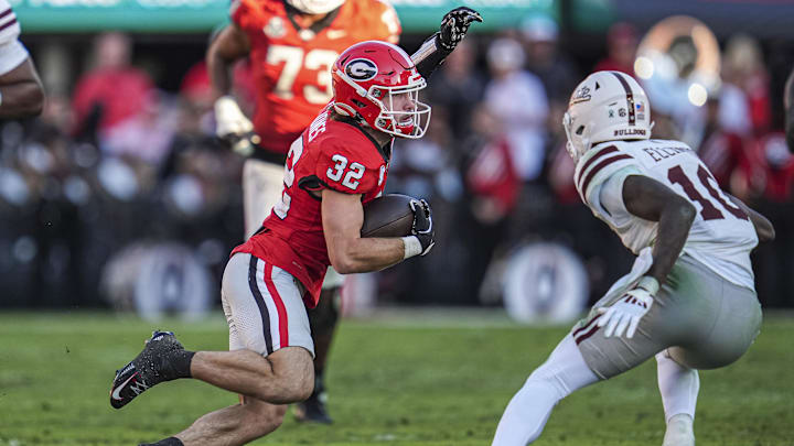 Oct 12, 2024; Athens, Georgia, USA; Georgia Bulldogs running back Cash Jones (32) runs against Mississippi State Bulldogs safety Corey Ellington (10) at Sanford Stadium. Mandatory Credit: Dale Zanine-Imagn Images
