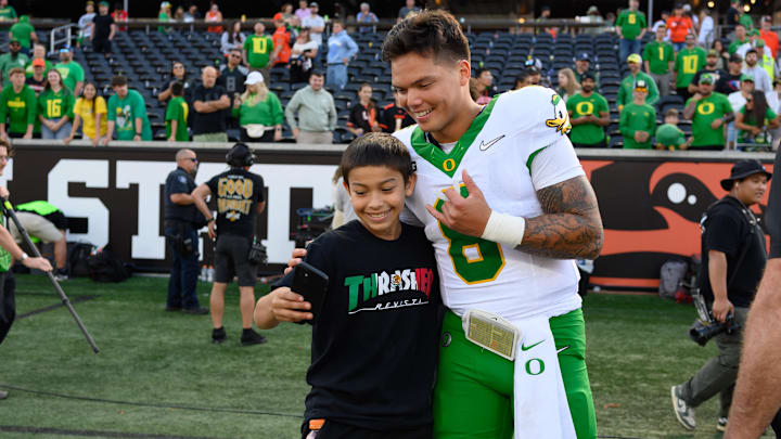 Sep 14, 2024; Corvallis, Oregon, USA; Oregon Ducks quarterback Dillon Gabriel (8) greets a fan after the game against the Oregon State Beavers at Reser Stadium. Mandatory Credit: Craig Strobeck-Imagn Images