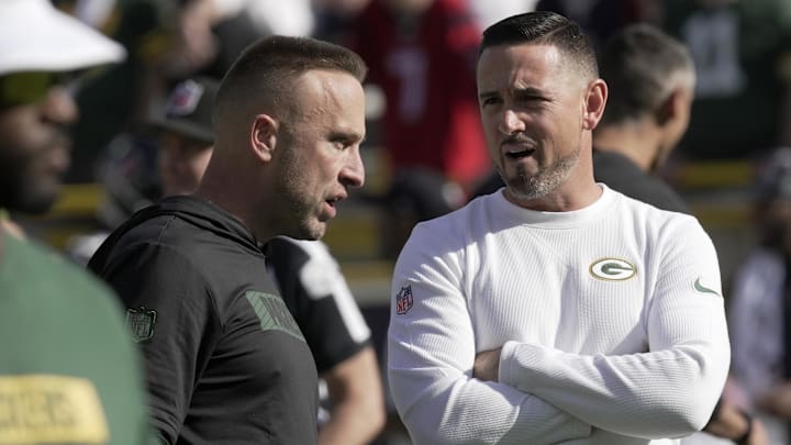 Oct 20, 2024; Green Bay, Wisconsin, USA; Green Bay Packers defensive coordinator Jeff Hafley, left, talks with head coach Matt LaFleur before their game against the Houston Texans at Lambeau Field.