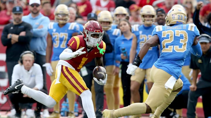 Nov 18, 2023; Los Angeles, California, USA; USC Trojans wide receiver Zachariah Branch (1) runs against UCLA Bruins defensive back Kenny Churchwell III (23) during the first quarter at United Airlines Field at Los Angeles Memorial Coliseum. Mandatory Credit: Jason Parkhurst-Imagn Images