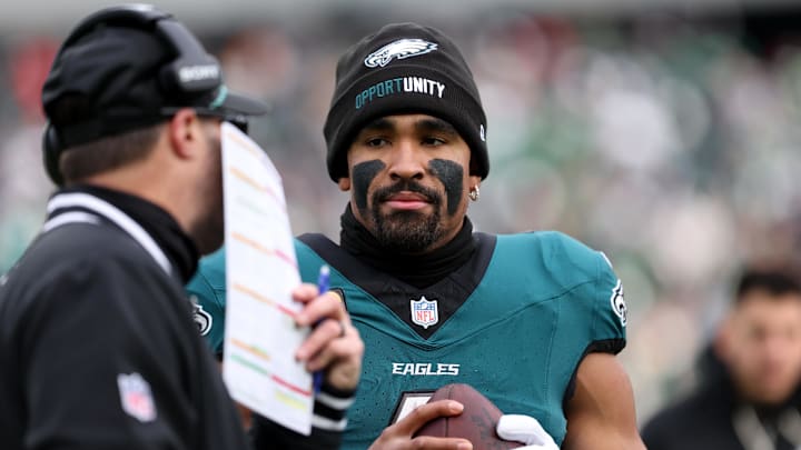 Dec 14, 2025; Philadelphia, Pennsylvania, USA; Philadelphia Eagles quarterback Jalen Hurts (1) speaks with offensive coordinator Kevin Patullo (left) during the first quarter against the Las Vegas Raiders before taking a possession at Lincoln Financial Field. Mandatory Credit: Bill Streicher-Imagn Images