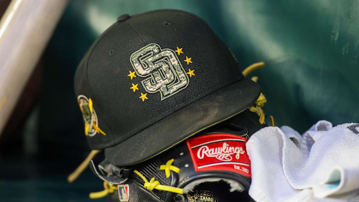 May 17, 2024; Atlanta, Georgia, USA; A detailed view of a San Diego Padres hat and glove on the bench against the Atlanta Braves in the third inning at Truist Park. Mandatory Credit: Brett Davis-Imagn Images May 17, 2024; Atlanta, Georgia, USA; A detailed view of a San Diego Padres hat and glove on the bench against the Atlanta Braves in the third inning at Truist Park. Mandatory Credit: Brett Davis-Imagn Images