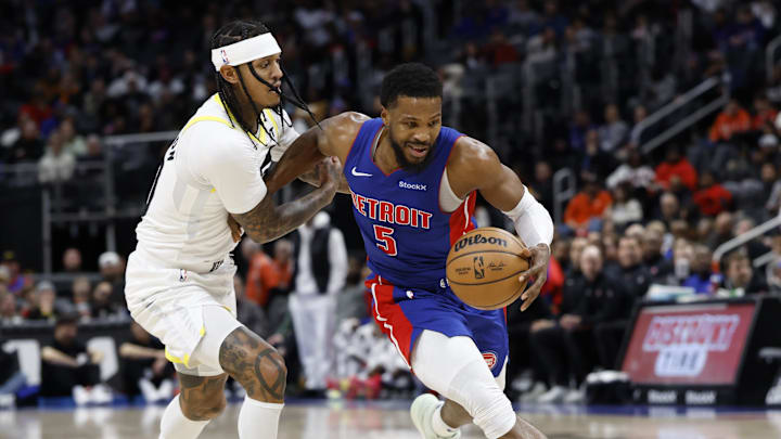 Dec 19, 2024; Detroit, Michigan, USA;  Detroit Pistons guard Malik Beasley (5) is defended by Utah Jazz guard Jordan Clarkson (00) in the first half at Little Caesars Arena. Mandatory Credit: Rick Osentoski-Imagn Images