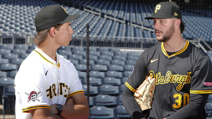 Jul 22, 2025; Pittsburgh, Pennsylvania, USA;  Seth Hernandez (left) the Pittsburgh Pirates first round and number six overall pick in the 2025 first year player draft talks with Pirates pitcher Paul Skenes (30) before the game against the Detroit Tigers at PNC Park. Mandatory Credit: Charles LeClaire-Imagn Images