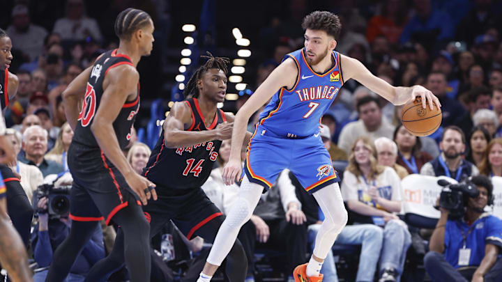 Feb 7, 2025; Oklahoma City, Oklahoma, USA; Oklahoma City Thunder forward Chet Holmgren (7) moves the ball against Toronto Raptors guard JaKobe Walter (14) during the second half at Paycom Center. Mandatory Credit: Alonzo Adams-Imagn Images Feb 7, 2025; Oklahoma City, Oklahoma, USA; Oklahoma City Thunder forward Chet Holmgren (7) moves the ball against Toronto Raptors guard JaKobe Walter (14) during the second half at Paycom Center. Mandatory Credit: Alonzo Adams-Imagn Images